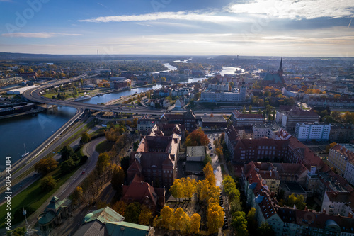 Szczecin from a bird's eye view on a sunny day. View of the city from the Oder River. City buildings, the seaport in Szczecin and its most characteristic places.