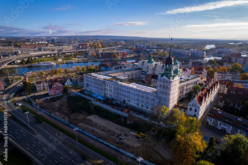 Szczecin from a bird's eye view on a sunny day. View of the city from the Oder River. City buildings, the seaport in Szczecin and its most characteristic places.