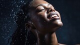 Portrait of a young woman with water splashing on a dark background, concept of beauty and skincare