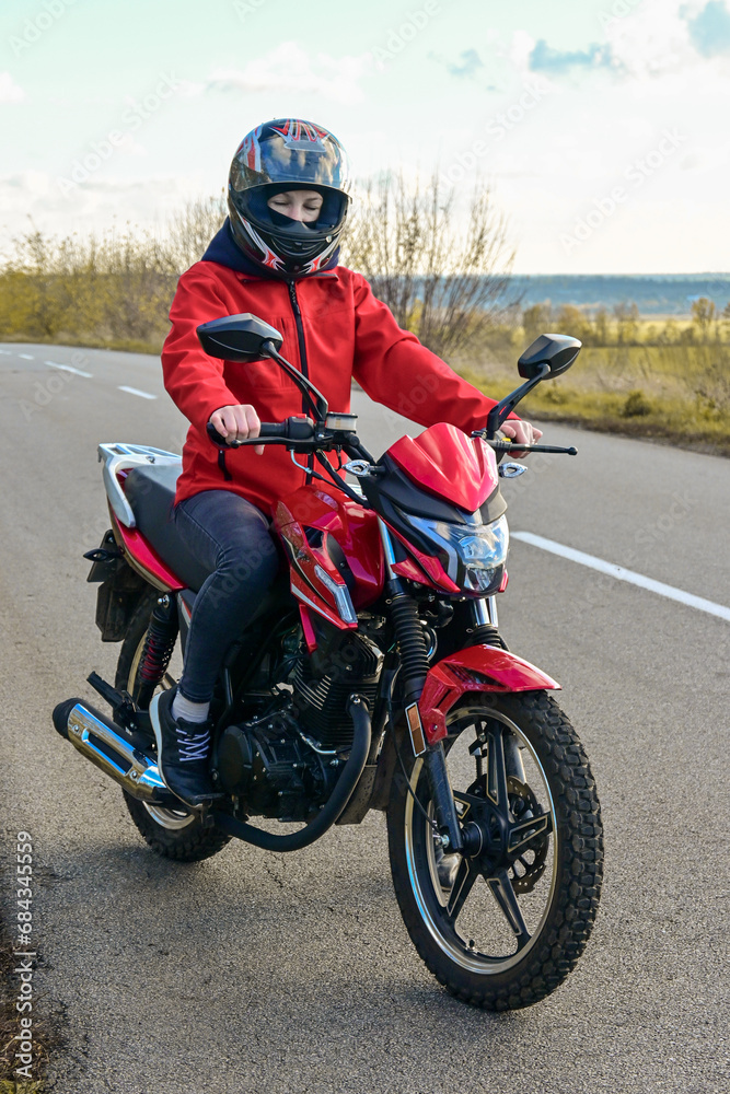 biker girl in red. red motorcycle. biker girl in red. red motorcycle.
