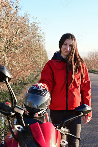 biker girl in red. red motorcycle.