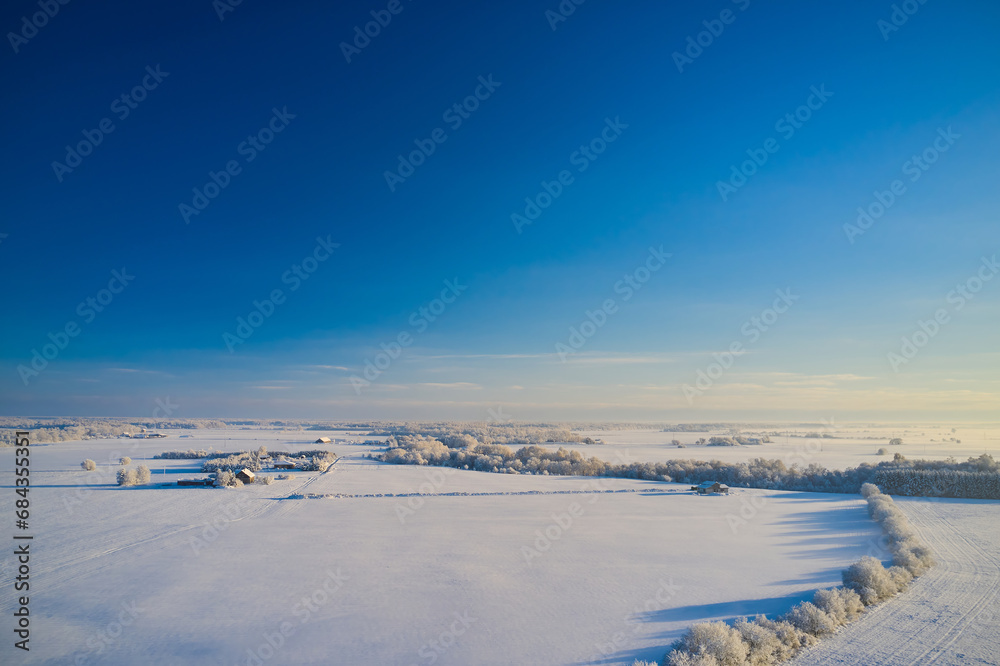 Winter panorama with a view of a small village in Lithuania. The concept of life on the farm