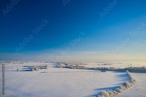 Winter panorama with a view of a small village in Lithuania. The concept of life on the farm