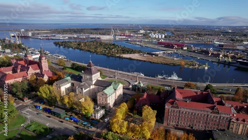 Szczecin from a bird's eye view on a sunny day. View of the city from the Oder River. City buildings, the seaport in Szczecin and its most characteristic places.