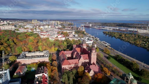 Szczecin from a bird's eye view on a sunny day. View of the city from the Oder River. City buildings, the seaport in Szczecin and its most characteristic places.