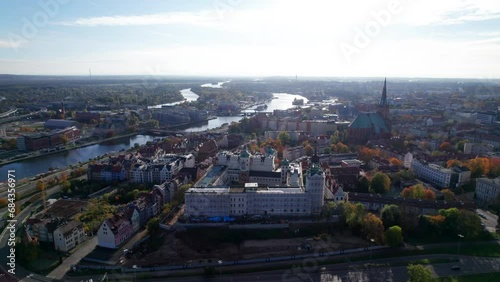 Szczecin from a bird's eye view on a sunny day. View of the city from the Oder River. City buildings, the seaport in Szczecin and its most characteristic places.