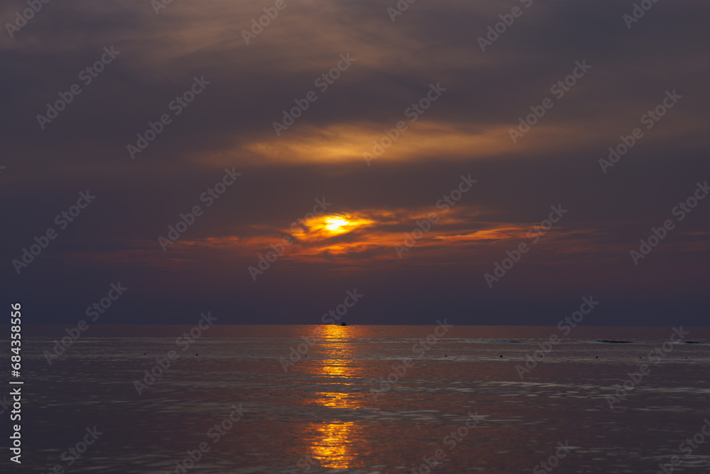 Dusk on the sea and dramatic sky, and sunny pathway.