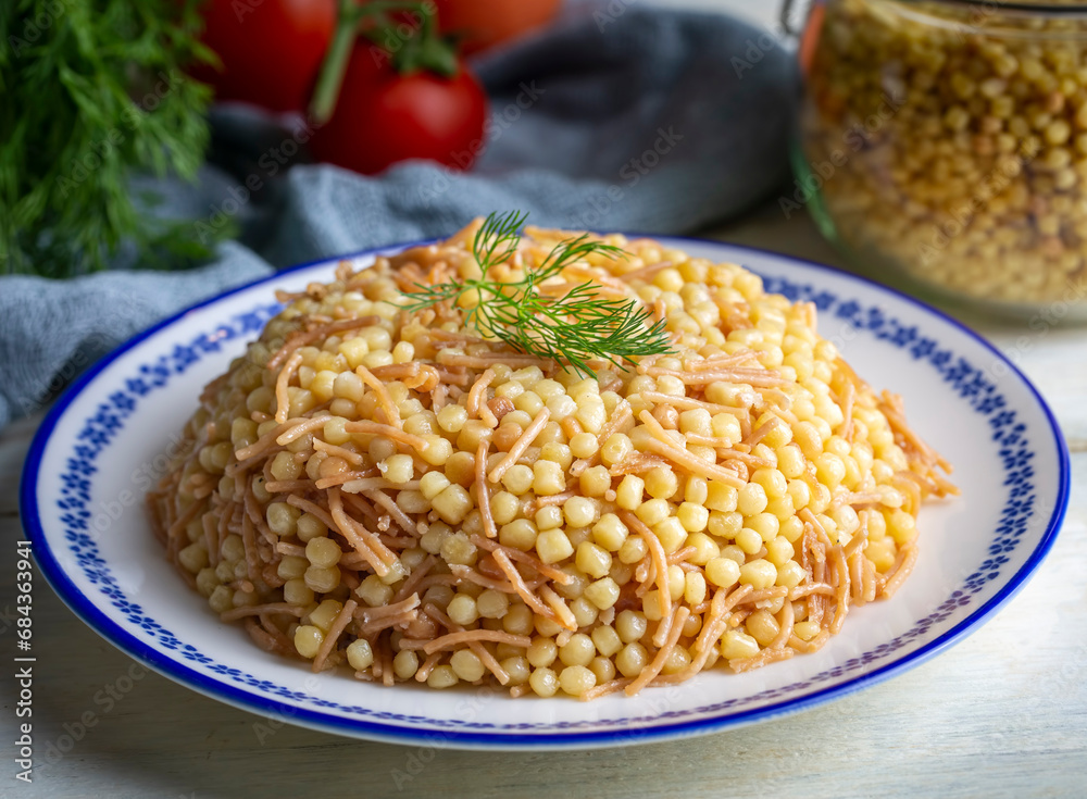 Traditional delicious Turkish food; Couscous pilaf with vermicelli (Turkish name; Sehriyeli kuskus pilavi) Traditional delicious Turkish food; Couscous pilaf with vermicelli (Turkish name; Sehriyeli kuskus pilavi)