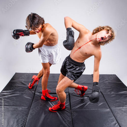 Bilde på lerret Teenage male boxer delivers a knockout punch to his opponent during a bloody box