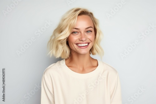 Young Attractive Fictional Norwegian Model Portrait. Beautiful Woman with Blond Hair and Blue Eyes in Casual Shirt Smiling Isolated on a Plain White Background. Generative AI. © Tuyres