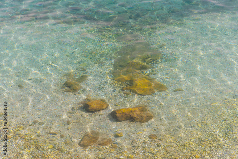 Fototapeta premium Stones in calm sea water.