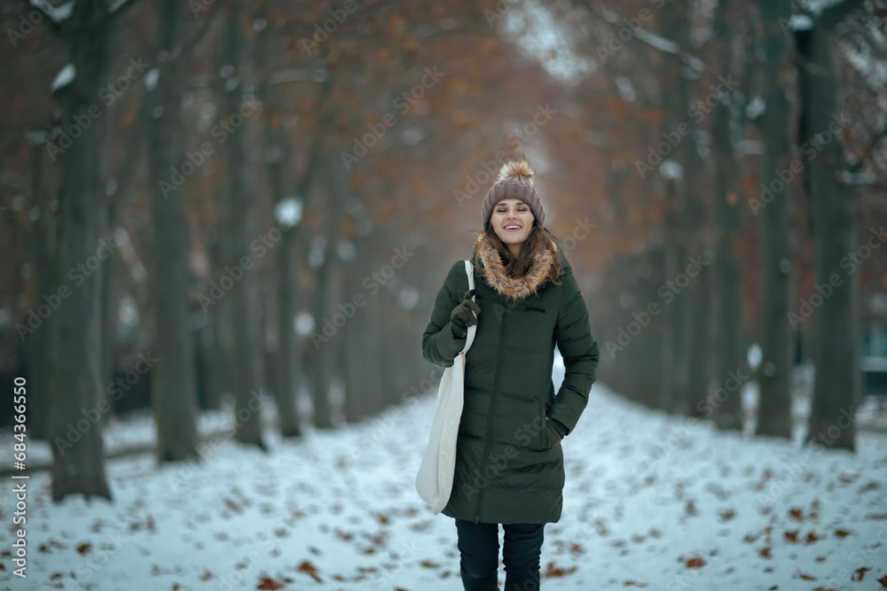 happy modern woman outdoors in city park in winter happy modern woman outdoors in city park in winter