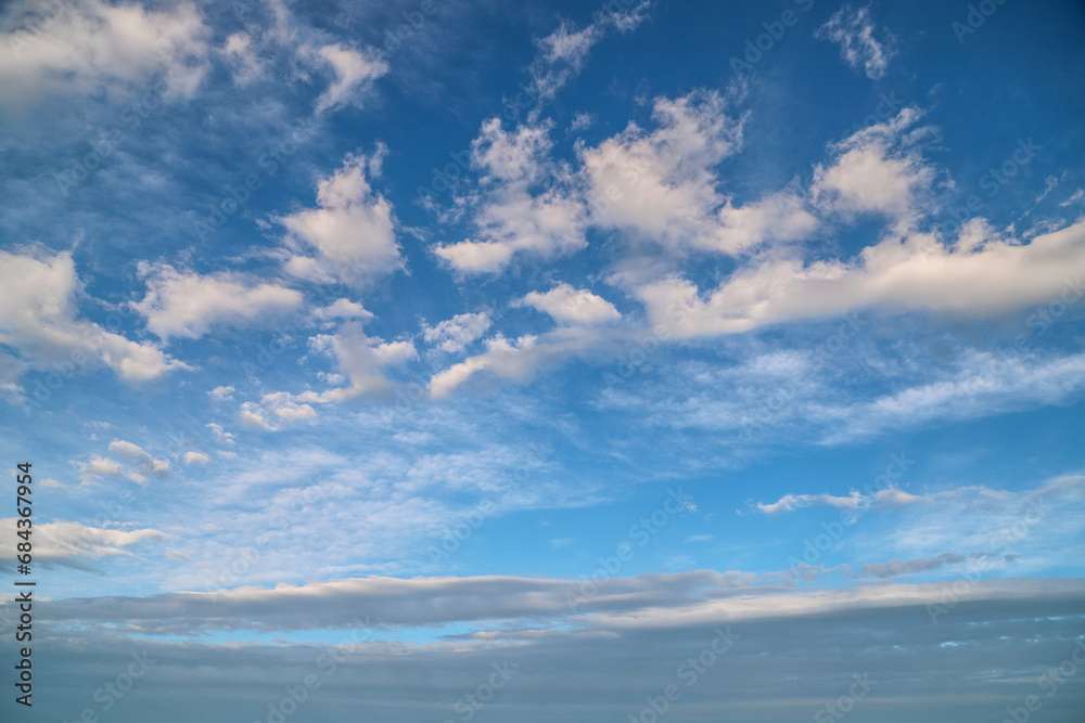 Blue sky with gray and white fluffy clouds. Abstract tranquil background Blue sky with gray and white fluffy clouds. Abstract tranquil background
