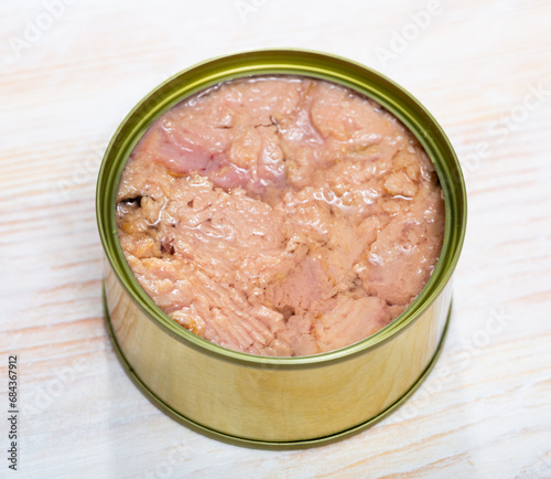 Canned tuna fish on a wooden table. High quality photo photo