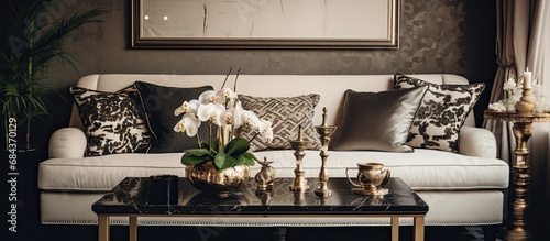 Elegant couch with pillows, adorned with knick-knacks, alongside a stylish coffee table. photo