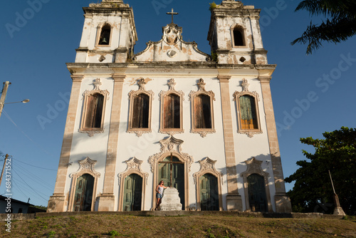 Tourist woman standing in front of the Santiago do Iguape church photo