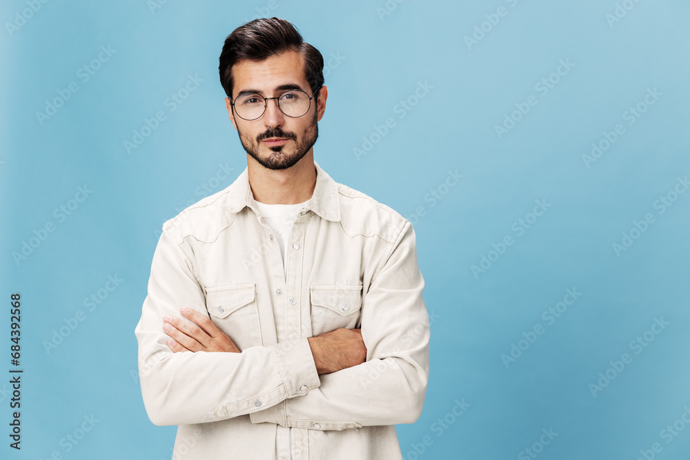 Portrait of a stylish man smile with teeth in glasses for farsightedness and myopia, on a blue background in a white T-shirt, fashionable clothing style, space space Portrait of a stylish man smile with teeth in glasses for farsightedness and myopia, on a blue background in a white T-shirt, fashionable clothing style, space space