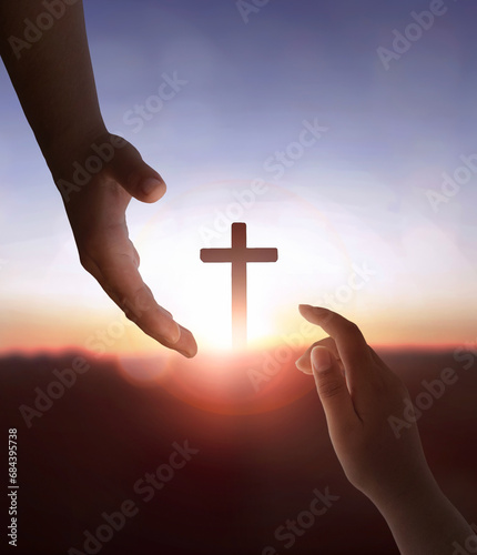 Jesus Christ reaching out to help human on cross background © paul