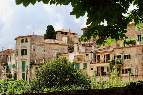 View of idyllic Valldemosa village old houses decorated with seasonal plants and flowers, Mallorca, Balearic Islands, Spain (all brand names and logos have been removed).