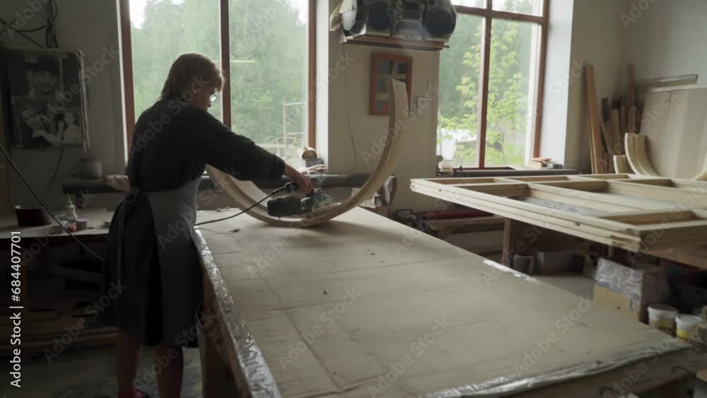 Wooden Window Production Workshop Artisan During Grinding Improvement Of Curved Part. Artisan Grinding Curved Wooden Piece At Handcrafting Workshop. Professional Grinding By Artisan At Workshop Wooden Window Production Workshop Artisan During Grinding Improvement Of Curved Part. Artisan Grinding Curved Wooden Piece At Handcrafting Workshop. Professional Grinding By Artisan At Workshop