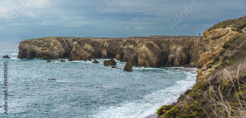 A breathtaking panorama showcasing the dramatic beauty of a coastal landscape, with rugged cliffs, crashing waves.