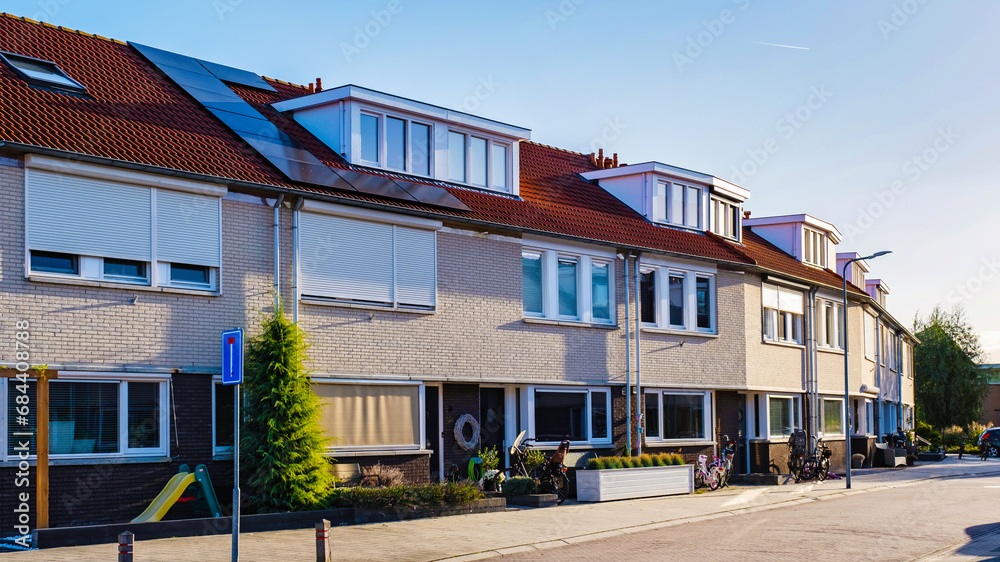 Dutch Suburban area with modern family houses, newly built modern family homes in the Netherlands, Row of modern houses in a family friendly suburban neighborhood on a sunny day