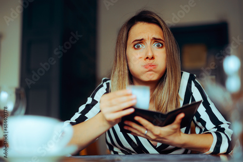 Unhappy Woman Receiving an Overpriced Bill in a Restaurant. Unhappy customer getting an inflated check at the diner 
 photo