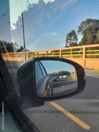 Image of traffic jam through a car's side-view mirror © Thantasorn