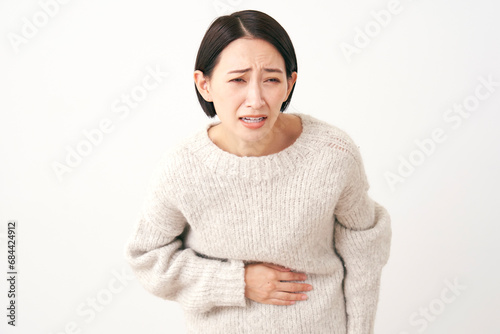 腹痛のミドルエイジの女性　白背景 photo