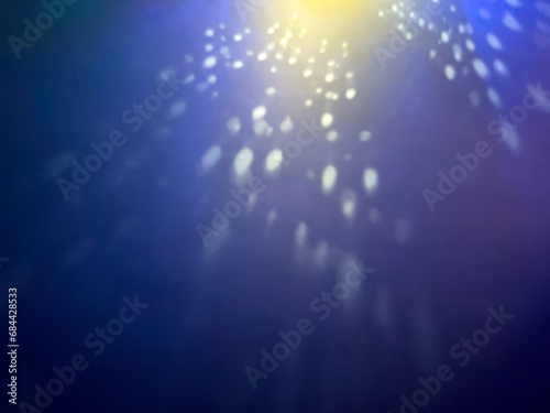 blue christmas background with colorful defocused spot light. new year theme.