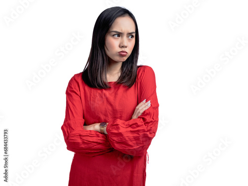 A portrait of an Asian woman wearing a red shirt, posing angrily with folded hands. Isolated against a white background. © Daniel