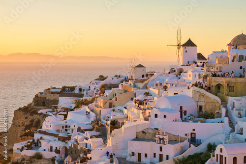 White churches an blue domes by the ocean of Oia Santorini Greece, traditional Greek village
