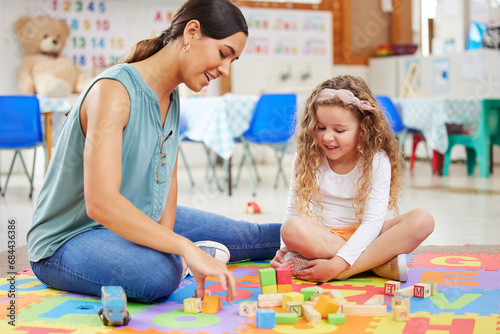 Woman, kid and toys for playing in classroom for learning, fun or development. Female teacher, little girl and colorful blocks for education, growth or milestone in childhood with exciting activity photo