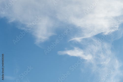 Canvas Print Early morning sky with wispy ethereal white clouds against a blue sky, as a natu