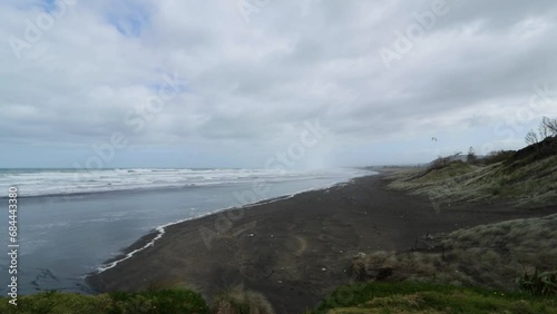 Muriwai Beach with big sea waves in bad weather: A Storm at New Zealand North Island Coast photo