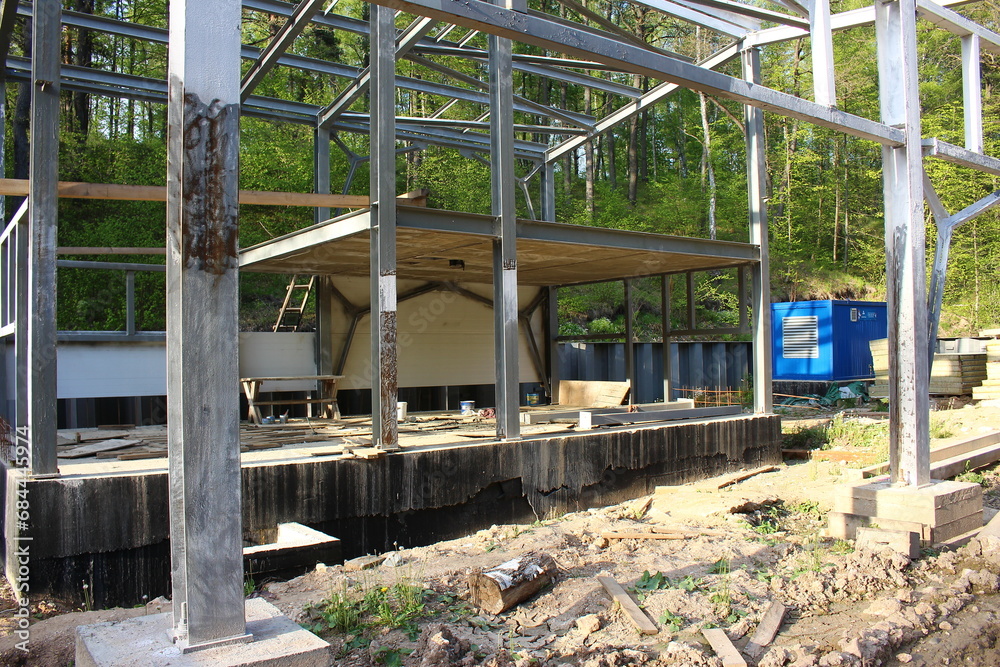 Metal frame of an industrial building in the process of construction. Construction of a sewerage pumping station