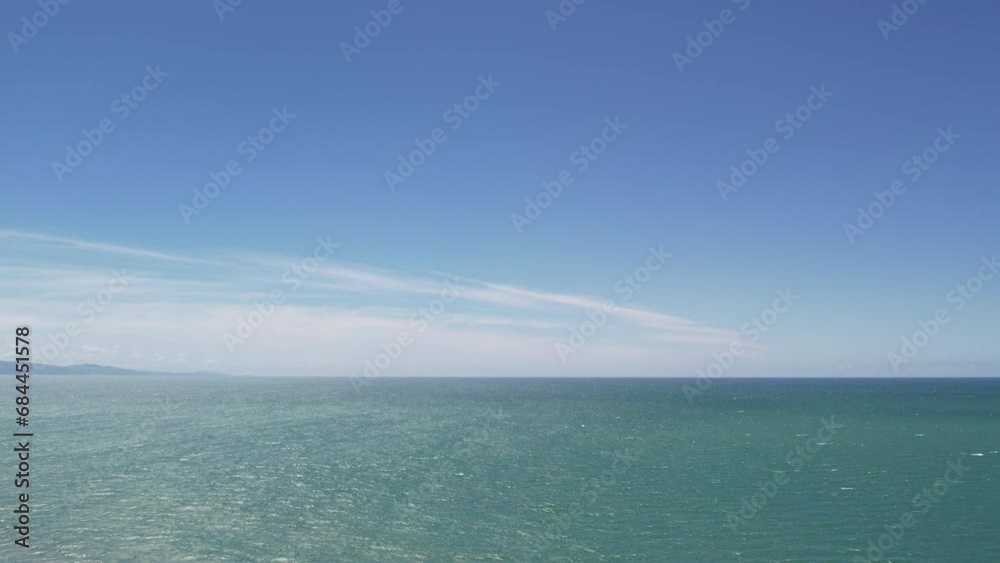 Slow aerial ascent and reverse above beautiful ocean on a sunny, windy day with shadows and patterns on water - Pegasus Bay, New Zealand Slow aerial ascent and reverse above beautiful ocean on a sunny, windy day with shadows and patterns on water - Pegasus Bay, New Zealand