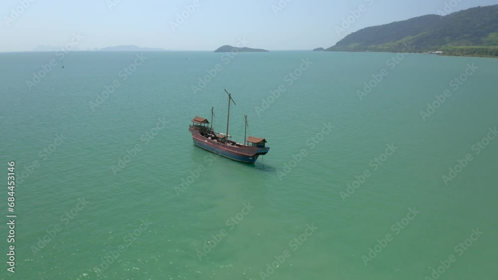 Circling around a large fishing boat moored off the coast of Old Town, Koh Lanta in southern Thailand. Shows the amazing landscape and the old fishing village. Circling around a large fishing boat moored off the coast of Old Town, Koh Lanta in southern Thailand. Shows the amazing landscape and the old fishing village.