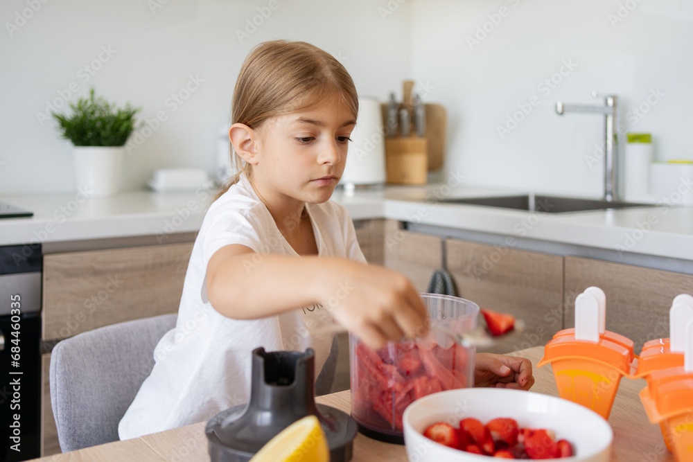 Portrait of cute child girl making ice cream. Kid have fun making with homemade fruit puree ice cream. Home made ice lollies. High quality photo Portrait of cute child girl making ice cream. Kid have fun making with homemade fruit puree ice cream. Home made ice lollies. High quality photo