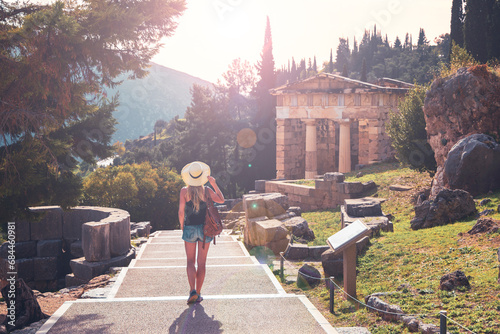 Woman tourist in Greece, Delphi touristic site at sunset