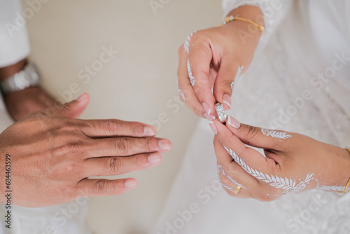 Hand of The Malay bride wears a wedding ring to the Malay groom.