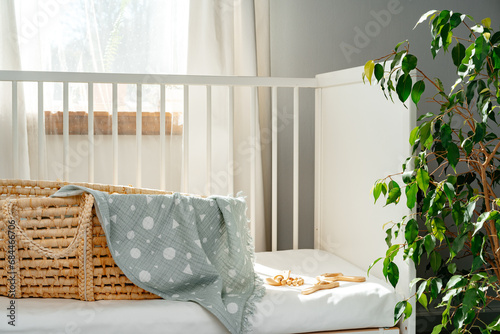Tableau sur toile Nursery interior and bedding for kids with wicker bassinet