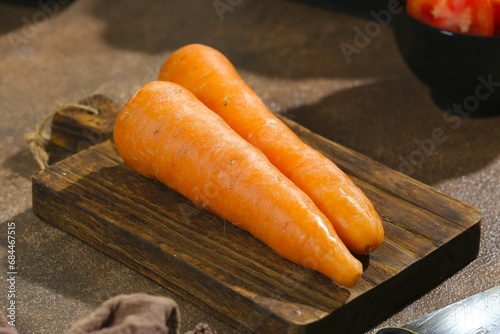 Carrot or carota on brown background. Healthy food. Wortel photo