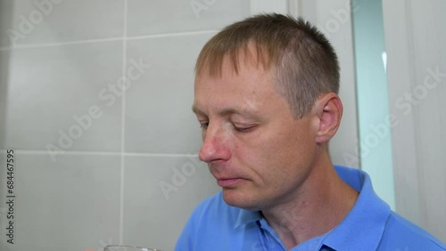 Wallpaper Mural Man takes a pill with a glass of clean water. The concept of treatment with medications at home. Close-up Torontodigital.ca