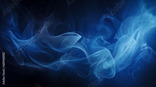 An image of blue smoke swirling against a dark background, creating a mysterious and ethereal effect.