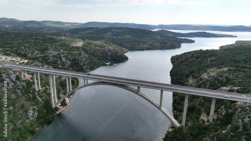 Aerial panoramic video of a beautiful deck arch bridge near the town of Šibenik in Croatia, on the Adriatic coast. Aerial panoramic video of a beautiful deck arch bridge near the town of Šibenik in Croatia, on the Adriatic coast.