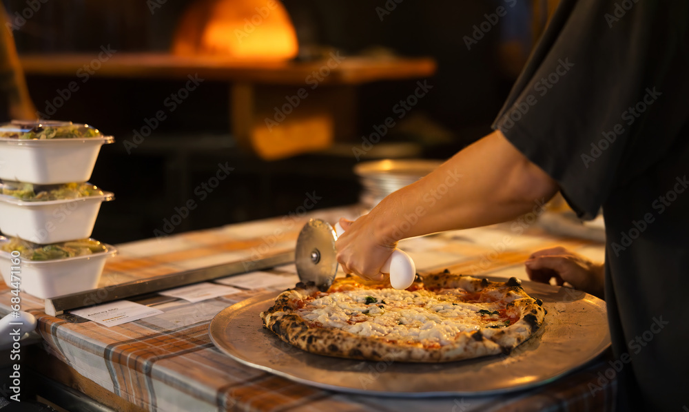 Cutting pizza in a pizzeria Cutting pizza in a pizzeria