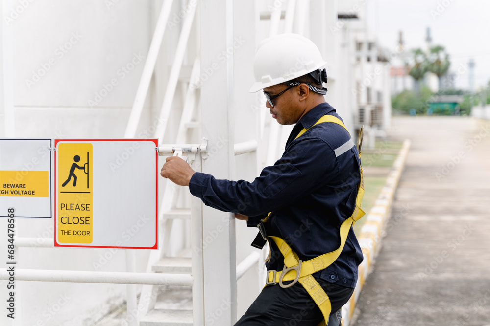 Close up of maintenance man working on site, maintenance man with building. 