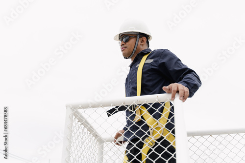 Close up of maintenance man working on site, maintenance man with building. 