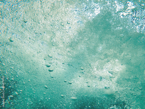 Underwater air bubbles in clean blue ocean water as natural background